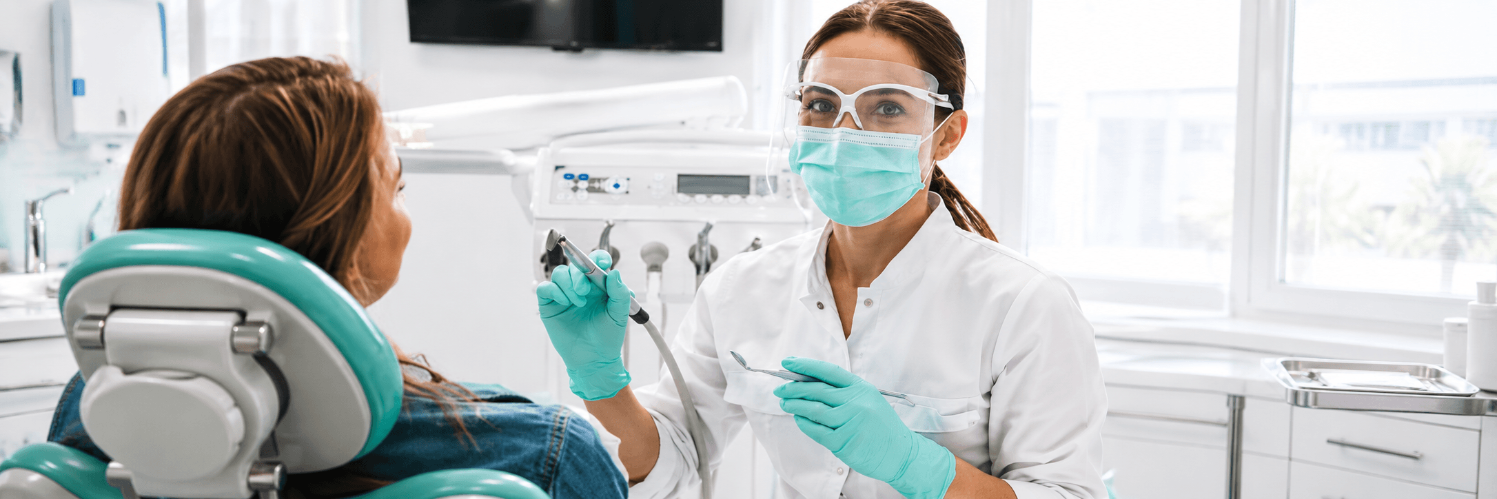 Dental front desk team greeting a patient