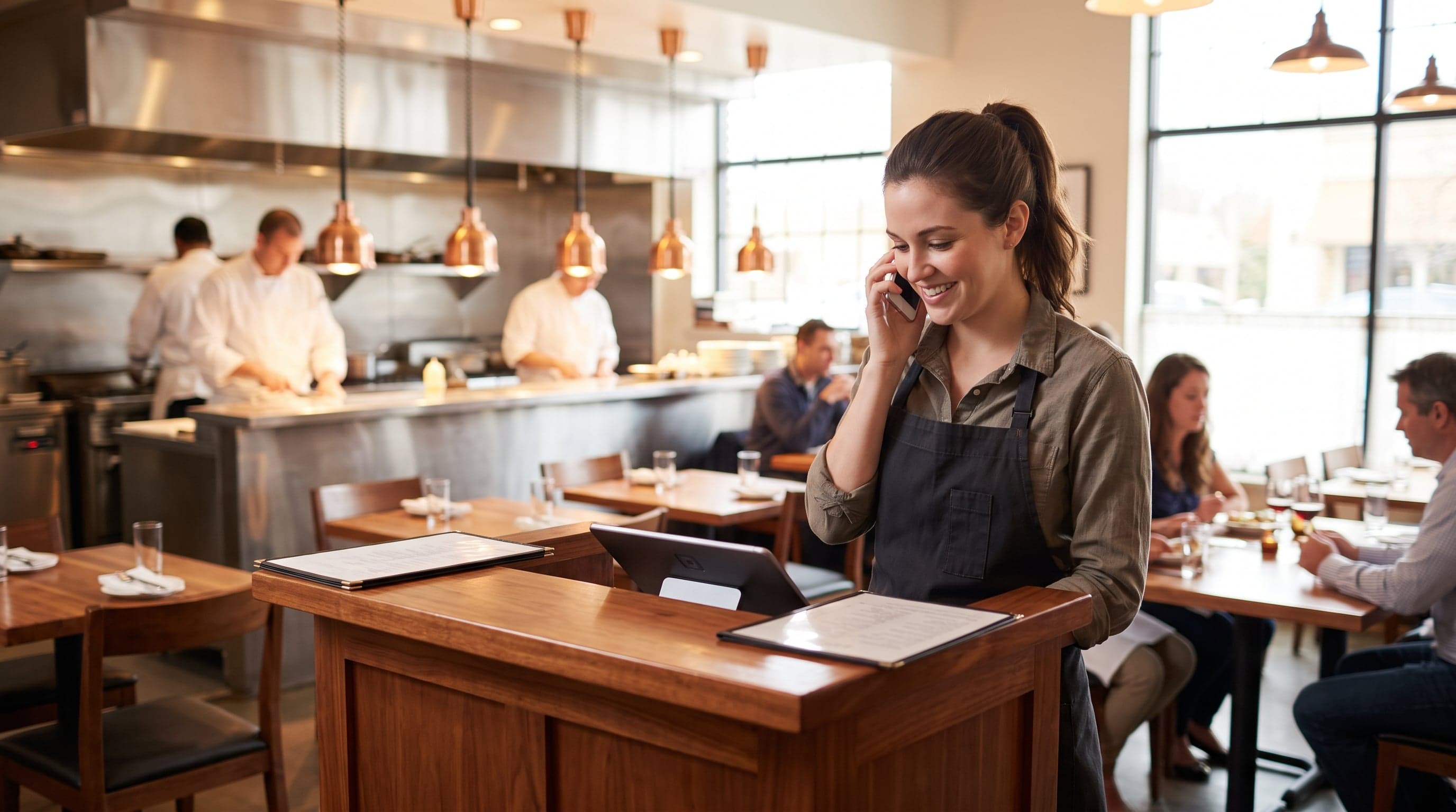 Busy restaurant host stand with staff at work